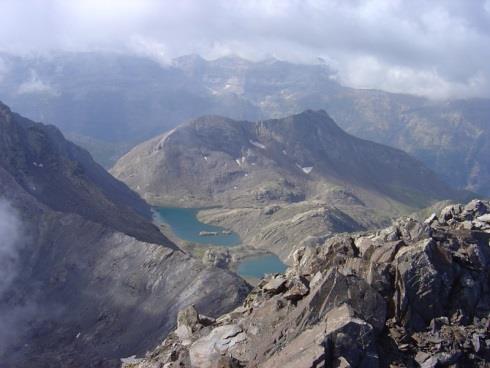 Rocky mountain slopes and a lake in the Pyrenees.