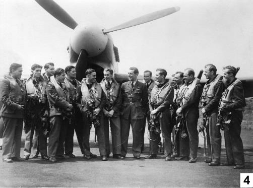 174 Squadron pilots standing together in front of an aircraft.